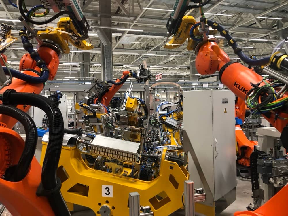 Makro pohled na oranžové roboty KUKA při integraci celku.